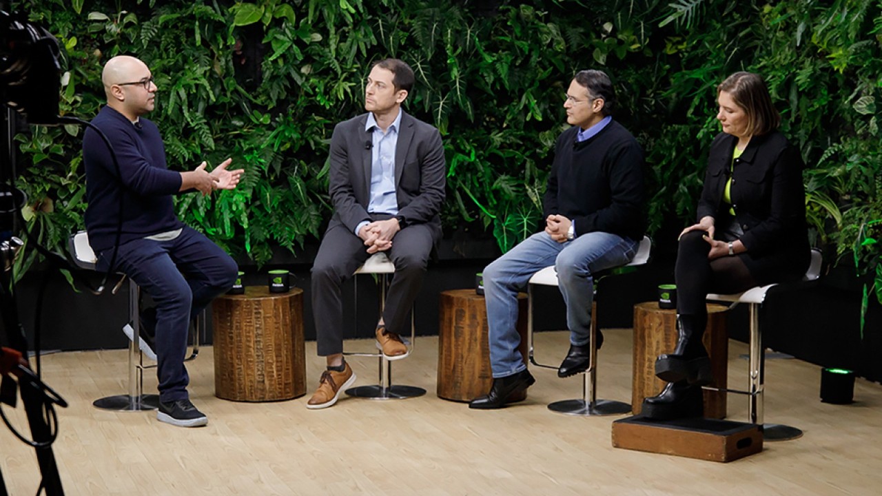 Business leaders discuss AI at a conference